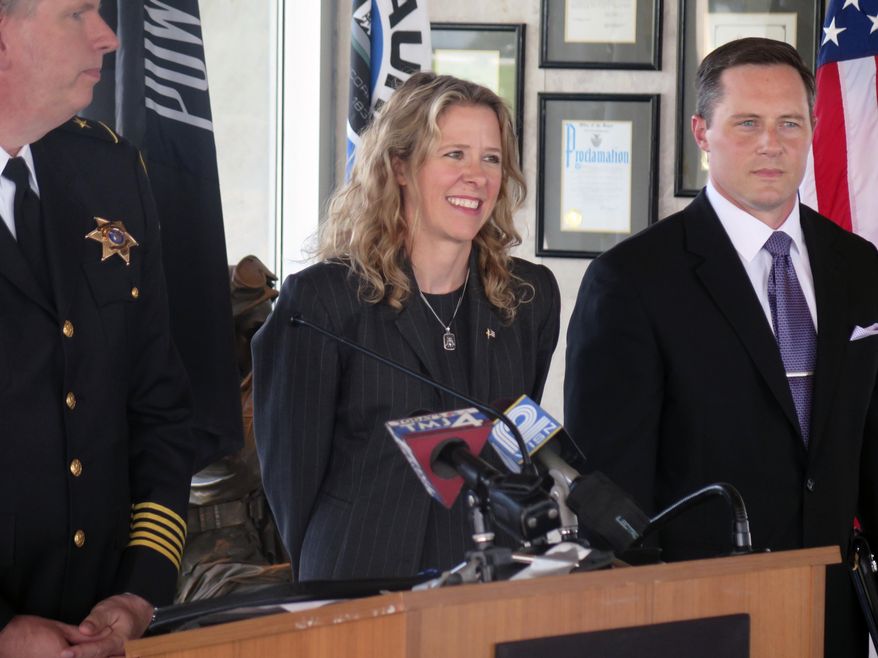 Judge Rebecca Bradley speaks as she kicks off her campaign for the Wisconsin Supreme Court, as Waukesha County Sheriff Eric Severson, left, and Walworth County District Attorney Dan Necci, right, look on Thursday, Sept. 17, 2015 in Milwaukee. (AP Photo/Greg Moore)