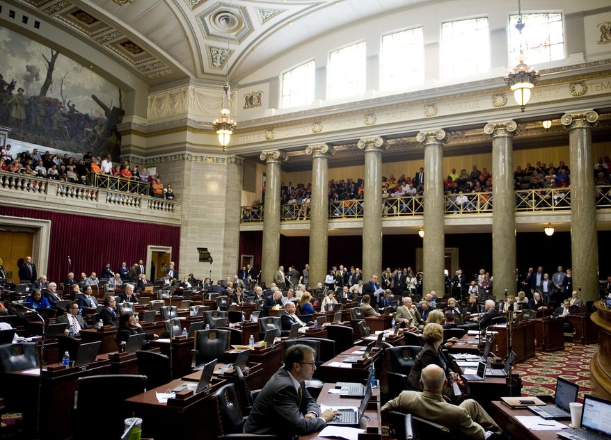 House of representatives members in the midst of the annual veto session, Wednesday, Sept. 16, 2015 at the Missouri State Capitol. Missouri's Republican-led House took the first step Wednesday toward enacting a ban on local minimum wages and began debating a highly contentious right-to-work bill that would bar mandatory union fees in workplaces. (Daniel Brenner/Columbia Daily Tribune via AP)