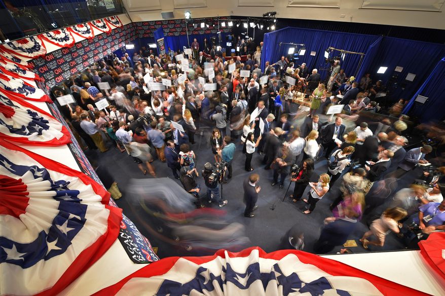 Journalists, candidates and their representatives crowd the spin room following the CNN Republican presidential debate at the Ronald Reagan Presidential Library and Museum on Wednesday, Sept. 16, 2015, in Simi Valley, Calif. (AP Photo/Mark J. Terrill)