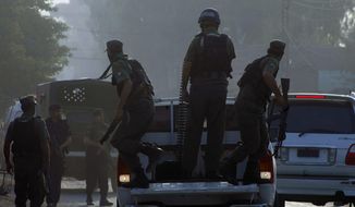Pakistani commandos arrive at an air force base in Peshawar, Pakistan, Friday, Sept. 18, 2015. Militants in northwestern Pakistan attacked an air force base on the outskirts of Peshawar early Friday, triggering a shootout that left at least 20 wounded and six of the attackers dead, officials said. (AP Photo/Mohammad Sajjad)