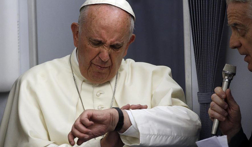 In this July 12, 2015, file photo, Pope Francis checks his watch as Vatican spokesman Federico Lombardi stands beside him, during an airborne press conference aboard the airplane directed to Rome, at the end of his Apostolic journey in Ecuador, Bolivia and Paraguay. The Pope plans to meet Cuba’s president and its priests, its young and its sick, its churchgoers and its seminarians as he travels across the island starting Saturday.  But not its dissidents. Vatican spokesman Federico Lombardi said that Francis had not accepted any invitations to meet with dissidents, and well-known opposition members told The Associated Press they have received no invitation to see him. (AP Photo/Gregorio Borgia, File)
