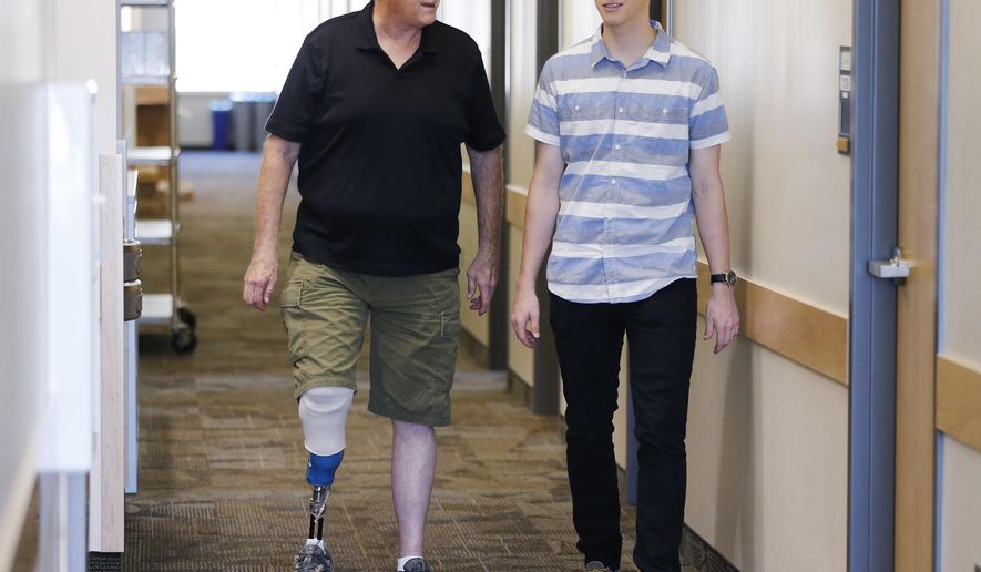 BYU student Jacob Hatch walks with his father Bryant on campus in Provo, Utah, Wednesday, Sept. 9, 2015. Bryant contracted MRSA, a bacteria that causes serious disease and death, and had to have one leg amputated. (Jeffrey D. Allred/The Deseret News via AP) SALT LAKE TRIBUNE OUT; MAGS OUT; MANDATORY CREDIT