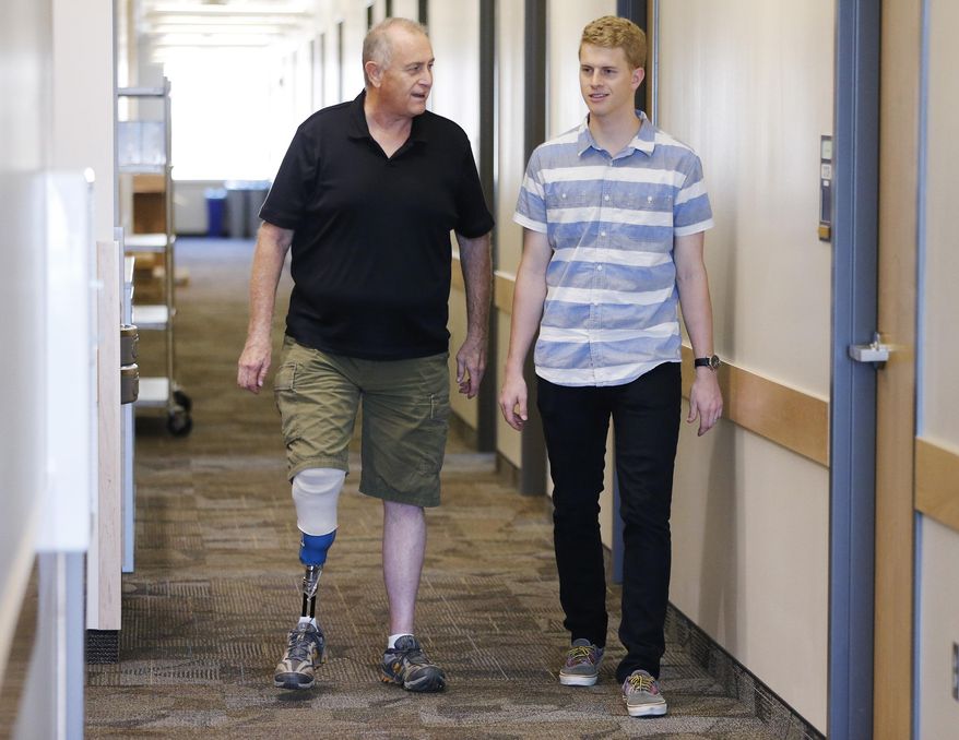 BYU student Jacob Hatch walks with his father Bryant on campus in Provo, Utah, Wednesday, Sept. 9, 2015. Bryant contracted MRSA, a bacteria that causes serious disease and death, and had to have one leg amputated. (Jeffrey D. Allred/The Deseret News via AP) SALT LAKE TRIBUNE OUT; MAGS OUT; MANDATORY CREDIT