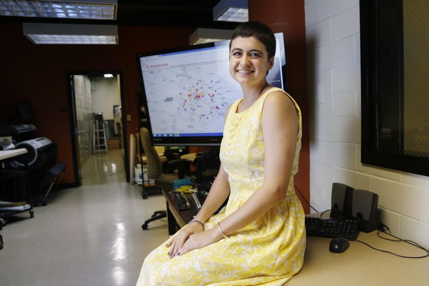 University of Kentucky senior Laura Greenfield displays a map with locator icons she created at her part time job at the Facilities Library in Lexington, Ky., on Sept. 10, 2015. Greenfield spent her last geography class creating an interactive map so single mothers to find resources in Lexington, such as daycare or counseling. (Pablo Alcala/Lexington Herald-Leader via AP)