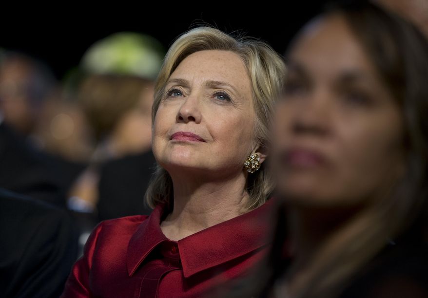 Democratic presidential candidate Hillary Rodham Clinton looks to President Barack Obama as he speaks on stage at the Congressional Black Caucus Foundation’s 45th Annual Legislative Conference Phoenix Awards Dinner at the Walter E. Washington Convention Center in Washington, Saturday, Sept. 19, 2015. The president spoke about black women's role in helping shape American democracy. (AP Photo/Carolyn Kaster)
