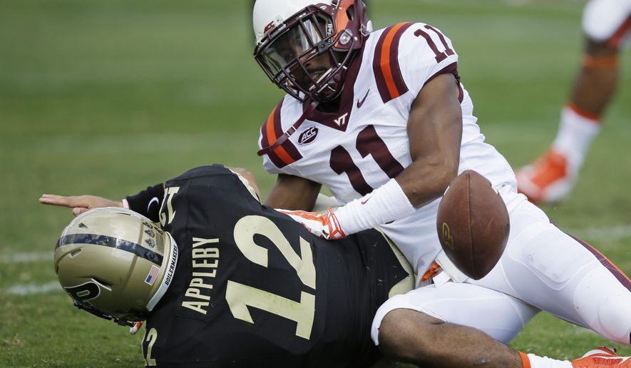 Purdue&#39;s Austin Appleby (12) fumbles after being tackled by Virginia Tech&#39;s Kendall Fuller (11) during the first half of an NCAA college football game Saturday, Sept. 19, 2015 in West Lafayette, Ind. (AP Photo/Darron Cummings)