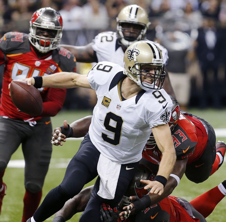 New Orleans Saints quarterback Drew Brees (9) is wrapped up by Tampa Bay Buccaneers defensive tackle Gerald McCoy (93) as he scrambles in the first half of an NFL football game against the Tampa Bay Buccaneers in New Orleans, Sunday, Sept. 20, 2015. The Buccaneers won 26-19. The Buccaneers won 26-19. (AP Photo/Bill Haber)