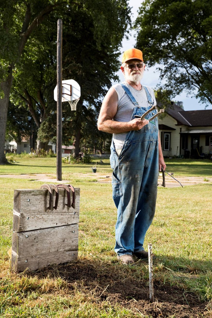 FOR RELEASE SUNDAY, SEPTEMBER 20, 2015, AT 12:01 A.M. CDT - In this Sept. 9, 2015 photo, horseshoe thrower Paul Mommens stands for a portrait outside his home in Worms, Neb. Mommens, who has been throwing horseshoes competitively for years, recently won his division at the World Horseshoe Tournament in Topeka Kan. (Matt Dixon/The Independent via AP) MANDATORY CREDIT
