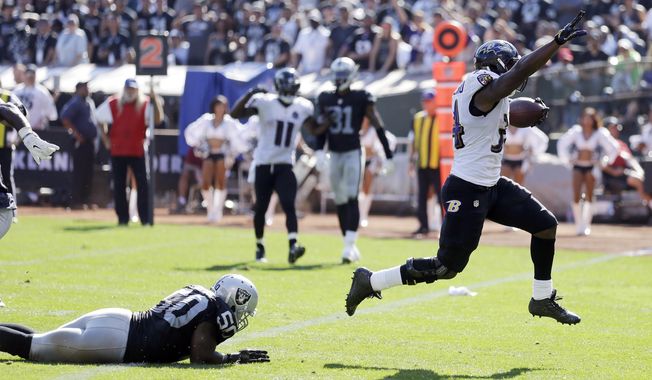 Baltimore Ravens&#x27; Lorenzo Taliaferro, right, runs in for a touchdown against the Oakland Raiders during an NFL football game Sunday, Sept. 20, 2015, in Oakland , Calif. (AP Photo/Ben Margot)