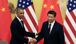 FILE - In this Nov. 12, 2014 file photo, U.S. President Barack Obama, left, shakes hands with his Chinese counterpart Xi Jinping after their press conference at the Great Hall of the People in Beijing, China. (AP Photo/Andy Wong, File)
