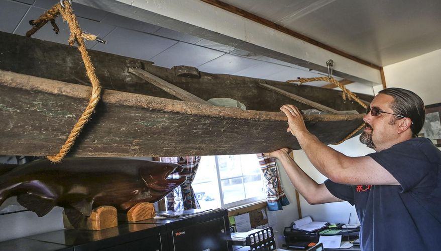 Tony Johnson shows a 'classic bay canoe given to former hereditary chief Lewis Hawkes when he was 12 at his office in Bay Center, Wash., Sept. 8, 2015. Every day for the last three months, the Chinook Indian Nation has addressed a letter to President Barack Obama about a subject that Johnson calls “a matter of life or death.” Johnson, 44, was speaking of the tribe’s long and frustrating effort to win federal recognition, a task he’s led since his election as tribal chairman in June. Federal recognition would make 2,700 Chinook nation members eligible for a wide range of federal health, education and other benefits and allow to the tribe to establish a reservation. (Bill Wagner / The Daily News via AP)