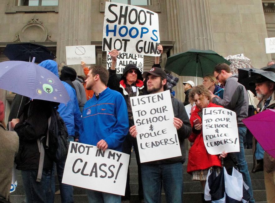 In this Feb. 27, 2014, file photo, protestors rally on the steps of the Idaho Statehouse in Boise, Idaho to protest SB1254, a bill seeking to allow concealed weapons on the state's college campuses. (AP Photo/John Miller, File)