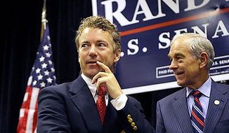Ron Paul is campaigning for his son, Republican presidential hopeful Sen. Rand Paul, saying their mutual belief in liberty scares the media. (Associated Press) ** FILE **