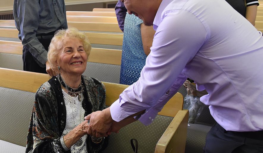 Violin teacher Helen DePastel is greeted by her former student Daniel Shen just before a concert and her 90th birthday celebration in her honor on Sept. 13, 2015 at the United Churches of Olympia, Wash. De Pastel was born in Berlin in 1925. She started playing music at age 6. At 14, she performed the first movement of Beethoven’s violin concerto with the Berlin Symphony, according to a short biography prepared by Karen De Pastel. (Steve Bloom/The Olympian via AP)
