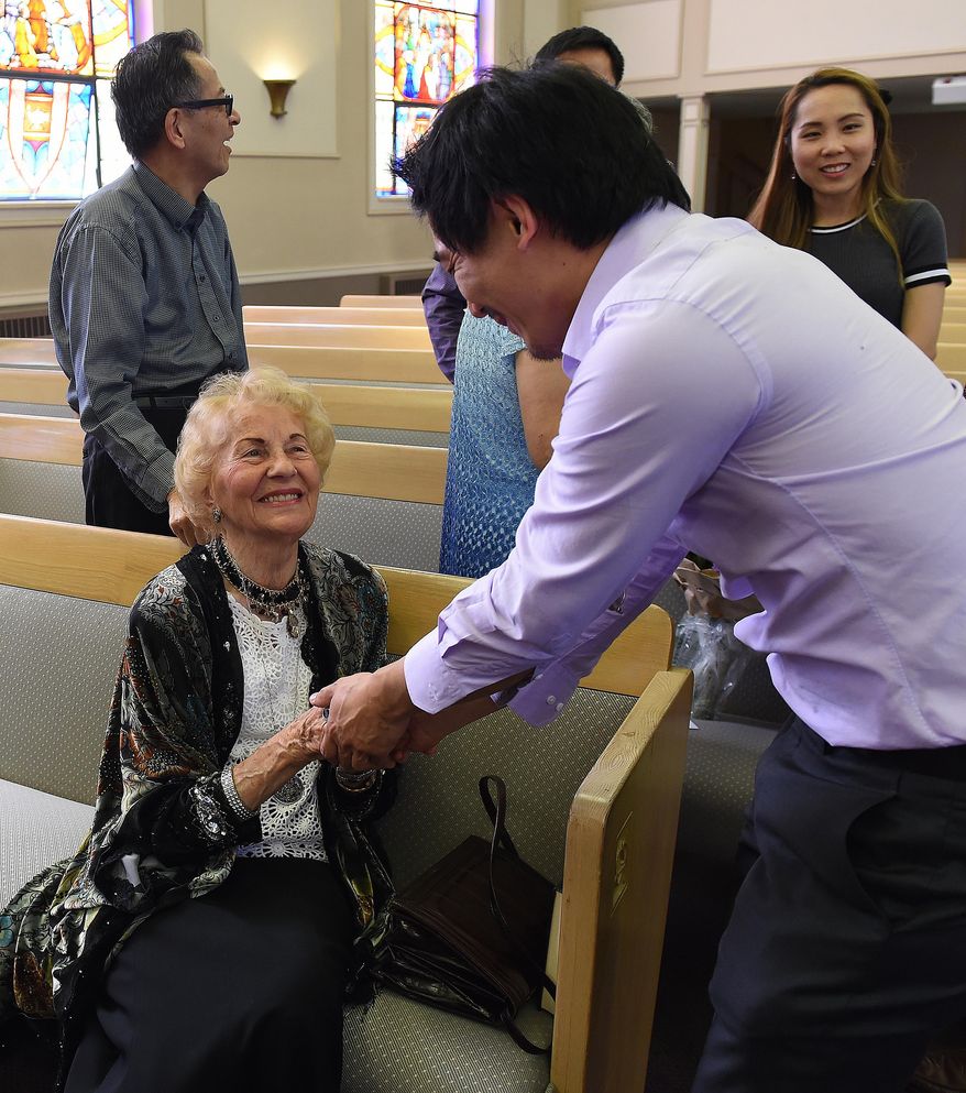 Violin teacher Helen DePastel is greeted by her former student Daniel Shen just before a concert and her 90th birthday celebration in her honor on Sept. 13, 2015 at the United Churches of Olympia, Wash. De Pastel was born in Berlin in 1925. She started playing music at age 6. At 14, she performed the first movement of Beethoven’s violin concerto with the Berlin Symphony, according to a short biography prepared by Karen De Pastel. (Steve Bloom/The Olympian via AP)