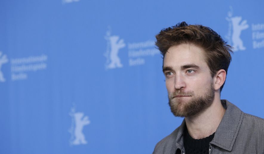A Monday, Feb. 9, 2015, photo from files of actor Robert Pattinson during the photo call for the movie "Life" at the 2015 Berlinale Film Festival in Berlin. The man relentlessly pursued by photographers is stepping into their shoes for his latest movie role. British heartthrob Robert Pattinson plays photographer Dennis Stock. (AP Photo/Michael Sohn, File)