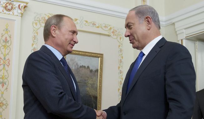 Russian President Vladimir Putin shakes hands with Israeli Prime Minister Benjamin Netanyahu, right, during their meeting in the Novo-Ogaryovo residence, outside Moscow, Russia, Monday, Sept. 21, 2015. (AP Photo/Ivan Sekretarev, Pool) **FILE**