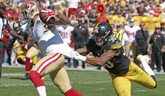 Pittsburgh Steelers inside linebacker Ryan Shazier (50) grabs San Francisco 49ers quarterback Colin Kaepernick (7) by the jersey as he scrambles in the fourth quarter of an NFL football game, Sunday, Sept. 20, 2015, in Pittsburgh. Kaepernick got loose but was tackled down field. (AP Photo/Gene J. Puskar)