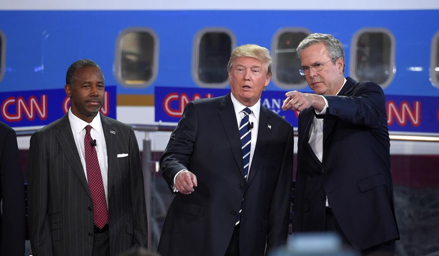 In this photo taken Wednesday, Sept. 16, 2015, Republican presidential candidates, from left, Ben Carson, Donald Trump, and former Florida Gov. Jeb Bush chat during the CNN Republican presidential debate at the Ronald Reagan Presidential Library and Museum in Simi Valley, Calif.  (AP Photo/Mark J. Terrill) ** FILE **