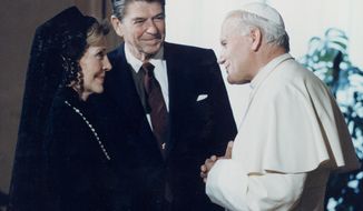 In this June 7, 1982 photo, U.S. President Ronald Reagan and his wife, first lady, Nancy Reagan, meet Pope John Paul II at the Vatican. (AP Photo/File)