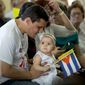 A child holds Cuban and Vatican flags during an homily by Pope Francis at the sanctuary of the Virgin of Charity in El Cobre, in Santiago,  Cuba, Tuesday, Sept. 22, 2015. (Ismael Francisco/Cubadebate via AP)