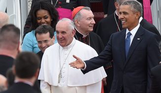 Pope Francis greets people as he is escorted by President Barack Obama after arriving at Andrews Air Force Base in Md., Tuesday, Sept. 22, 2015. The Pope is spending three days in Washington before heading to New York and Philadelphia. This is the Pope&#39;s first visit to the United States. (AP Photo/Susan Walsh)