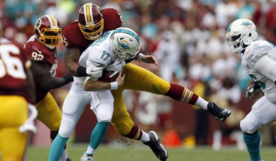 Miami Dolphins quarterback Ryan Tannehill (17) is sacked by Washington Redskins defensive end Jason Hatcher (97) during the first half of an NFL football game Sunday, Sept. 13, 2015, in Landover, Md. (AP Photo/Patrick Semansky)
