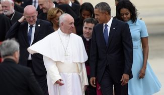 Pope Francis talks with President Barack Obama, accompanied by first lady Michelle Obama, after arriving at Andrews Air Force Base in Md., Tuesday, Sept. 22, 2015. The Pope is spending three days in Washington before heading to New York and Philadelphia. This is the Pope&#39;s first visit to the United States. (AP Photo/Susan Walsh)