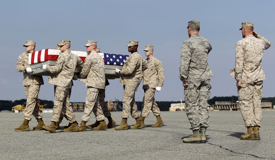 A Marine carry team moves a transfer case containing the remains of Lance Cpl. Gregory T. Buckley, 21, of Oceanside, N.Y., Monday, Aug. 13, 2012, at Dover Air Force Base, Del. (Associated Press)