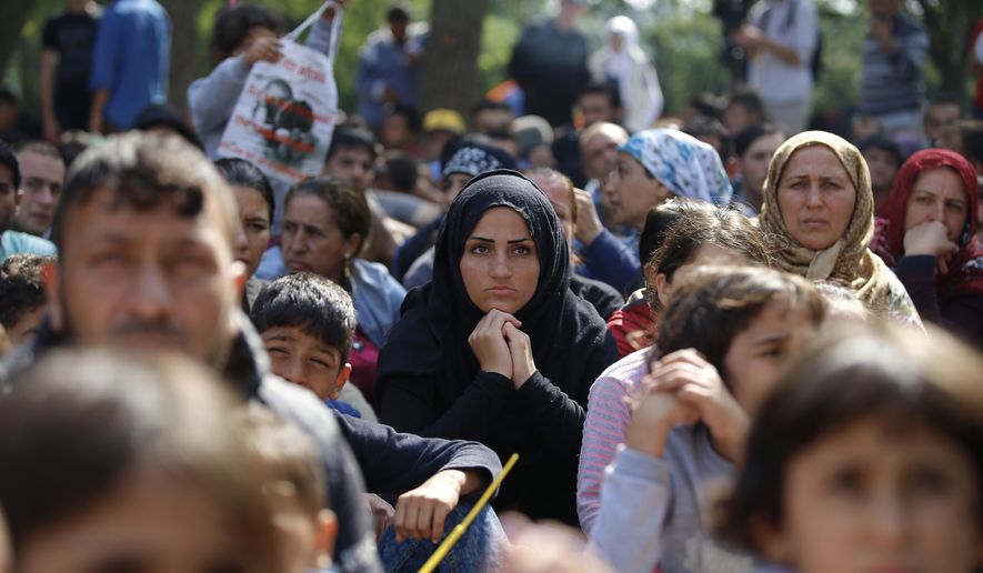 Migrants, mostly Syrians, listen to an Arabic speaker talk to them about their future as they rest in a stadium used for traditional Kirkpinar Oil Wrestling, while waiting to cross to Europe near Turkey’s western border with Greece and Bulgaria, in Edirne, Turkey, Wednesday, Sept. 23, 2015. Hundreds of migrants have made the trek to Edirne in the hope of being allowed to cross into neighboring Greece or Bulgaria and avoid the often-risky journey across the Aegean Sea. Many arrived last week but have been blocked from approaching the border by law enforcement.(AP Photo/Emrah Gurel)