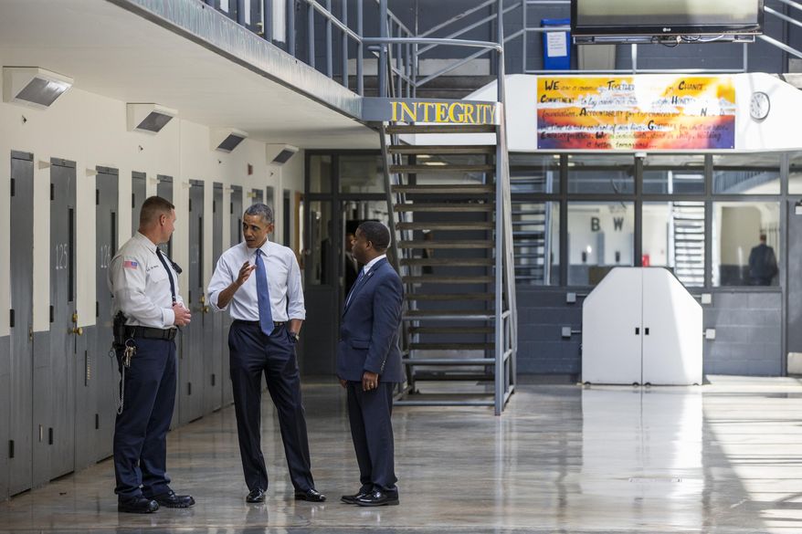 President Barack Obama speaks during a tour with the Bureau of Prisons Director Charles Samuels (right) and correctional officer Ronald Warlick at the El Reno Federal Correctional Institution in El Reno, Okla., on July 16, 2015. An HBO documentary, "Fixing the System," that features President Obama's historic visit to the prison and his in-depth conversations with six of the inmates, premiered Wednesday, Sept. 23, 2015, at the prison before a group of inmates. (Associated Press) **FILE**
