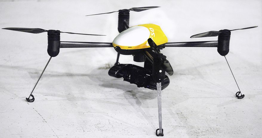 FILE - In this June 24, 2014 file photo, hows the Draganflyer X4-ES drone, a professional, GPS guided, four-rotor UAV helicopter capable of autonomous flight, video and digital still images, during a demonstration in Grand Forks, N.D. Organizers of an annual unmanned aircraft conference are calling North Dakota the Silicon Valley of the drone world. Some of the top aerospace experts in the country are meeting Wednesday, Sept. 23, 2015, in Grand Forks to talk about research and business opportunities in the state. (AP Photo/Bruce Crummy, File)