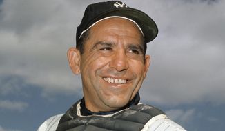In this undated file photo, New York Yankee catcher Yogi Berra poses at spring training in Florida. The Hall of Fame catcher renowned as much for his lovable, linguistically dizzying &quot;Yogi-isms&quot; as his unmatched 10 World Series championships with the New York Yankees, died Tuesday, Sept. 22, 2015. He was 90. (AP Photo/File)