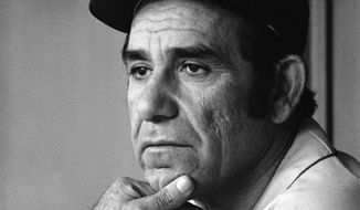 File-This Sept. 21, 1973, file photo shows Yogi Berra, manager of the New York Mets, watching his team work during a game in Philadelphia. Berra, the Yankees Hall of Fame catcher has died. He was 90. (AP Photo/Ray Stubblebine, File)