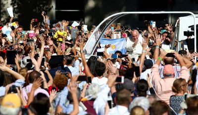 mass crowd: Pope Francis arrives in the popemobile at the Basilica of the National Shrine of the Immaculate Conception on Wednesday for the canonization Mass for Junipero Serra.
