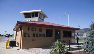 A Secret Service police officer stands outside El Reno Federal Correctional Institution in El Reno, Okla. (AP Photo/Evan Vucci, File)