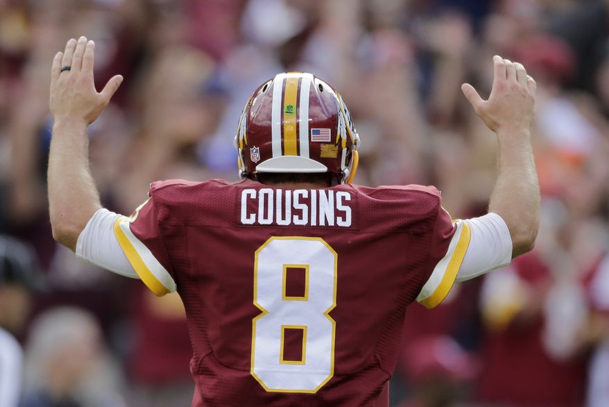 Washington Redskins quarterback Kirk Cousins reacts to running back Matt Jones&#39; touchdown during the second half of an NFL football game against the St. Louis Rams in Landover, Md., Sunday, Sept. 20, 2015. The Redskins defeated the Rams 24-10. (AP Photo/Mark Tenally)