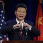 Chinese President Xi Jinping talks about how the Chinese symbol for the word &quot;people&quot; resembles two sticks supporting each other as he speaks Tuesday, Sept. 22, 2015, at a banquet in Seattle. Xi was in Seattle on his way to Washington, D.C., for a White House state dinner on Friday. (AP Photo/Ted S. Warren)