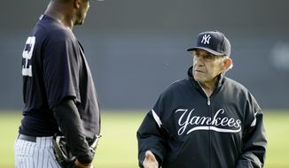 This Feb. 24, 2011, file photo shows New York Yankees pitcher CC Sabathia, left, talking with Yogi Berra, right, during a baseball spring training workout at Steinbrenner Field in Tampa, Fla. Berra, the Yankees Hall of Fame catcher has died. He was 90.( AP Photo/Charlie Neibergall, File)