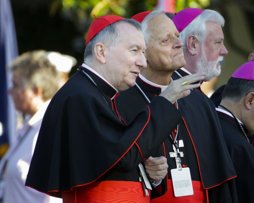 Vatican Secretary of State Cardinal Pietro Parolin, left, and Cardinal Donald Wuerl, archbishop of Washington, right, talk before taking their seats on the South Lawn of the White House in Washington, Wednesday, Sept. 23, 2015, for a state visit hosted by President Barack Obama for Pope Francis. (AP Photo/Pablo Martinez Monsivais)