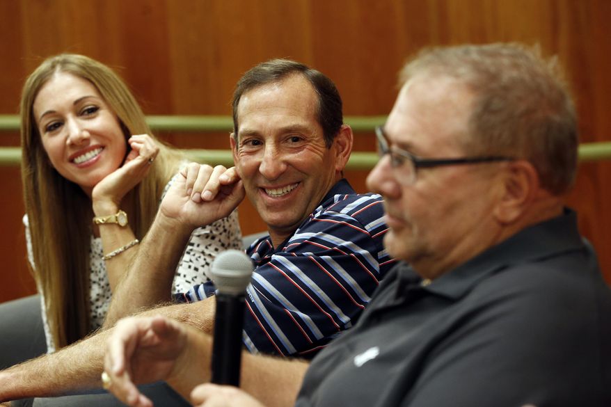 Yogi Berra's oldest granddaughter Lindsay Berra, left, and Dale Berra, son of the New York Yankees hall of fame catcher, listen as Larry Berra speaks about the passing of their father at the Yogi Berra Museum, Thursday, Sept. 24, 2015, in Little Falls, N.J. Berra died Tuesday at the age of 90. (AP Photo/Julio Cortez)