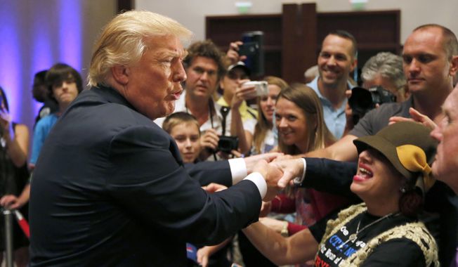 Republican presidential candidate, businessman Donald Trump, greets supporters after speaking at an event sponsored by the Greater Charleston Business Alliance and the South Carolina African American Chamber of Commerce at the Charleston Area Convention Center in North Charleston, S.C., Wednesday, Sept. 23, 2015. (AP Photo/Mic Smith) ** FILE **