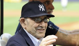 New York Yankees Hall of Fame catcher Yogi Berra waves to the fans before the baseball game against the Baltimore Orioles at Yankee Stadium, Friday, Aug. 30, 2013, in New York. (AP Photo/Bill Kostroun)