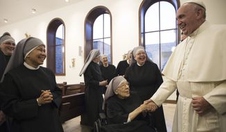 In this photo taken Wednesday, Sept. 23, 2015, Pope Francis greets nuns of the Little Sisters of the Poor order during a private meeting at their convent, in Washington. The Little Sisters of the Poor is a religious order that is suing the Obama administration over a requirement in the Affordable Care Act that employers provide health insurance that covers birth control. (L&#39;Osservatore Romano/Pool Photo via AP)