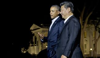 President Obama and Chinese President Xi Jinping walk on the North Lawn of the White House in Washington, Thursday to a private dinner at the Blair House, across the street from the White House. (Associated Press)