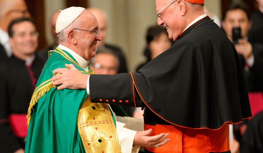 Pope Francis and Cardinal Timothy Dolan, right, embrace during an evening prayer service at St. Patrick&#x27;s Cathedral, Thursday, Sept. 24, 2015, in New York. (Robert Deutsch/USA Today via AP, Pool)