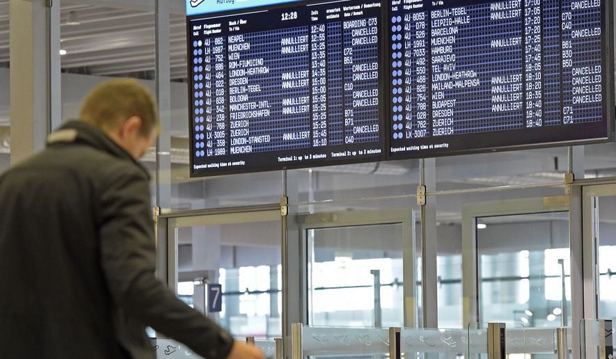 In this Oct. 16, 2014 file photo, a board shows canceled flights of German airline Germanwings at the airport in Cologne, Germany, as their pilots went on strike. Business travelers stuck in airports either due to unforeseen delays due to weather or strikes, or because of wait time for connecting flights, can turn those stressful, empty hours into sightseeing with a little planning and a sense of adventure. (AP Photo/Martin Meissner, File)