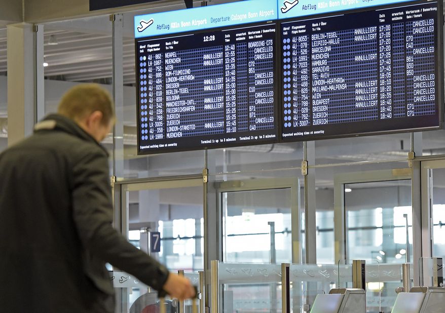 In this Oct. 16, 2014 file photo, a board shows canceled flights of German airline Germanwings at the airport in Cologne, Germany, as their pilots went on strike. Business travelers stuck in airports either due to unforeseen delays due to weather or strikes, or because of wait time for connecting flights, can turn those stressful, empty hours into sightseeing with a little planning and a sense of adventure. (AP Photo/Martin Meissner, File)