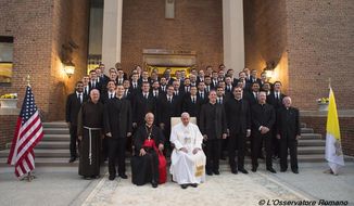 In this photo taken Wednesday, Sept. 23, 2015, Pope Francis poses for a family photo with members oh the Saint Pope John Paul II seminary, in Washington. (L&#39;Osservatore Romano/Pool Photo via AP)