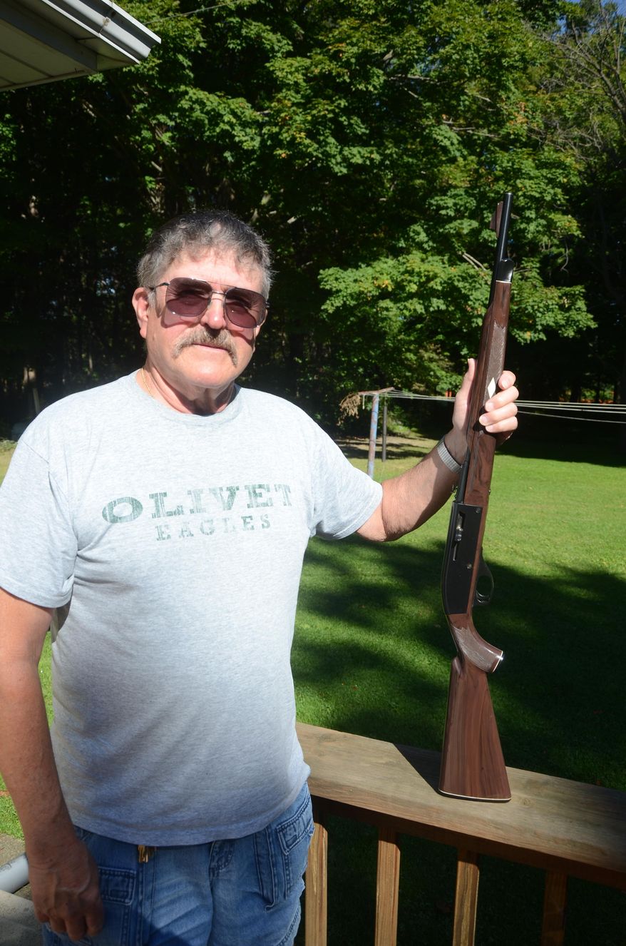 In this photo taken Wednesday, Sept. 23, 2015, Richard Montague, 72, poses in Lee Township, Mich., with the rifle which was stolen Sept. 1, 1982, and just recently returned after police recovered it in Tennessee. (Trace Christenson/Battle Creek Enquirer via AP) NO SALES; MANDATORY CREDIT